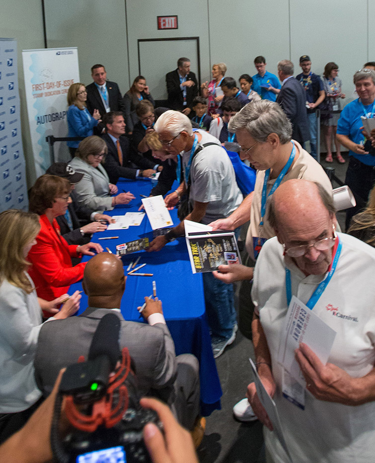 WASHINGTON — Nearly 50 years to the day of the original airing of “Star Trek,” the U.S. Postal Service dedicated the Star Trek Forever stamps today at New York City’s Jacob K. Javits Convention Center. The first-day-of-issue ceremony launched Star Trek: Mission New York, a three-day celebration that is expected to draw thousands of Star Trek fans. These stamps will “live long and prosper,” because as Forever stamps they are good for mailing a 1-ounce First-Class letter anytime in the future — regardless of star date. “Star Trek” fans are asked to share the news on social media using the hashtag #StarTrekForever. “The Postal Service is proud to commemorate ‘Star Trek’ on the eve of its 50th anniversary,” said Postmaster General Megan J. Brennan referring to the iconic television program’s Sept. 8, 1966, debut. “Star Trek’s intricate futuristic setting, multicultural cast and story lines touched on social issues and pushed past the boundaries of popular science fiction becoming a worldwide phenomenon.” Joining Brennan in dedicating the stamps were actor and humanitarian Walter Koenig, who portrayed U.S.S. Enterprise’s navigation officer Pavel Chekov in the series; NASA Deputy Director of Science for Communication Michelle Thaller; CBS Consumer Products Executive Vice President and General Manager Liz Kaloduer; and, U.S. Postal Service Chief Postal Inspector Guy Cottrell. “With the chaos in today’s world, hopefully the stamps and what they signify can inspire a better future for us all,” said Koenig. “’Star Trek’ gave us a universe that we could explore in our imagination,” said Thaller. “In this universe we pioneered not only new technology and new worlds, but — more importantly — new social rules and new definitions of tolerance and diversity. In Star Trek’s universe, we found better ways to be human.” Iconic TV series Star Trek stamps released The stamps, under license by CBS Consumer Products, show